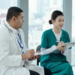 Image of two healthcare professionals taking notes