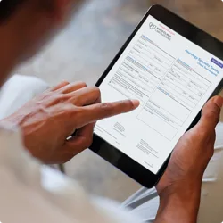 Image of healthcare professional reading an article on an electronic tablet
