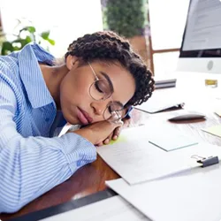 Image of woman sleeping on desk