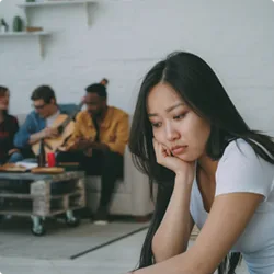 Image showing woman sitting alone in a social environment