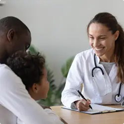 Image of clinician conducting interview with pediatric patient and caregiver