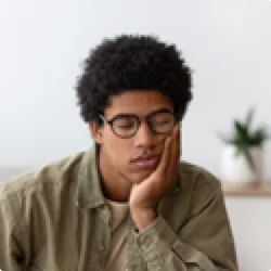 Image of teenager asleep propped up on elbow with head in hand